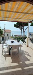 a table and chairs under an umbrella on a patio at Perla del Mare in Sperlonga