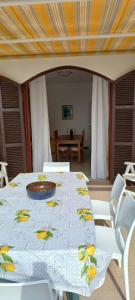 a table with a white table cloth with a plate on it at Perla del Mare in Sperlonga +20 photos