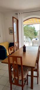 a dining room table and chairs with a view of a patio at Perla del Mare in Sperlonga