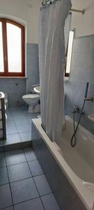 a bathroom with a shower and a tub and a sink at Perla del Mare in Sperlonga