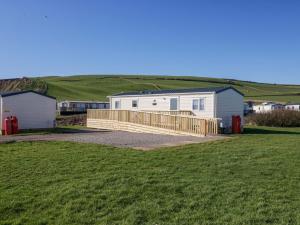 a house with a wooden fence in a field at Guillemot in St Bees