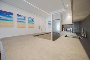 a kitchen with a counter top and a refrigerator at Bañeru Zarautz Centro - Sol, playa y confort, todo a un paso in Zarautz