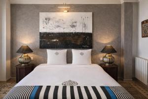 a bedroom with a large bed with two lamps at Le balcon de tanger in Tangier
