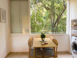 a dining room with a table and a window at White Emerald in Haifa
