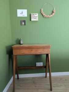 a wooden table in a room next to a wall at Maison Terracotta in Saint-Priest-en-Jarez