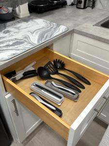 a drawer with knives and utensils in a kitchen at Miami Stay - Pool, Parking, & Affordable Transportation in Tamiami