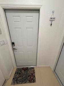 a white door with a sign that reads exit at Miami Stay - Pool, Parking, & Affordable Transportation in Tamiami