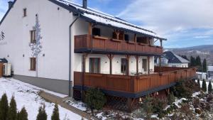 a house with a balcony on the side of it at Apartamenty Black Lion in Pcim +117 photos