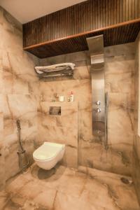 a bathroom with a toilet and a shower at Samar Villa BnB in Shimla +72 photos