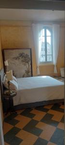 a bedroom with a large bed and a window at Millenovecento in Cremona