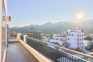 a balcony with a view of the mountains at ArionHotel in Ninh Hải