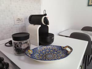 a counter with a coffee maker and a plate on it at Sole e relax da Michelle in Anzio