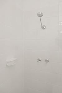 a shower with two water faucets in a bathroom at Georgies Simple Base in Mosman Park in Mosman Park