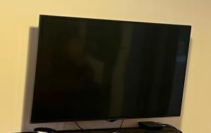 a flat screen tv sitting on top of a table at La charmante petite maison in Croix