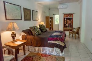a bedroom with a bed and a table and chairs at Creekside Oasis in San Felipe +21 photos