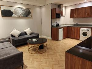 a living room with a couch and a table at Smayah Residence Hotel in Riyadh