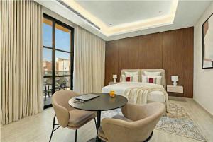a hotel room with a bed and a table and chairs at LIV by Yamama - KAFD in Riyadh