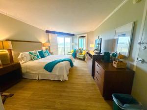 a bedroom with a bed and a television in it at Pristine Hotel Room at Popular Resort in Lihue +26 photos