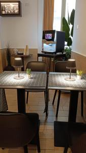 two tables with plants on them in a room at H22 Hotel in Naples +20 photos