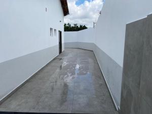 a hallway of a white building with a concrete floor at Espaço Guga in Sorocaba