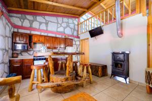 a kitchen with wooden cabinets and a stove at Cabañas las Gemelas in Areponapuchi