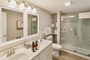 a bathroom with a sink and a toilet and a shower at USS Anderson in Waukegan +28 photos