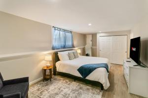 a bedroom with a bed and a flat screen tv at USS Anderson in Waukegan