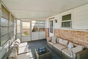 a living room with a couch and a brick wall at USS Anderson in Waukegan