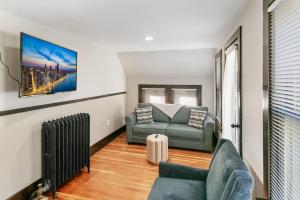 a living room with a couch and a chair at USS Maddox in Libertyville