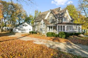 an old house in the fall with leaves on the ground at USS Maddox in Libertyville