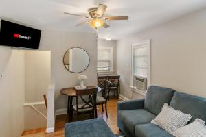 a living room with a couch and a table at Cozy 2 bed Apt 2 train stops to the Naval Base in Highwood