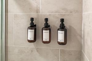 three bottles of essential oils on a wall in a bathroom at USS Russell in Highwood +28 photos