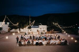 a group of people sitting at tables at a wedding at Masseria Mozzone in Fasano