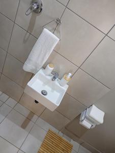 a bathroom with a sink and two rolls of toilet paper at Ashdown BnB in Pietermaritzburg
