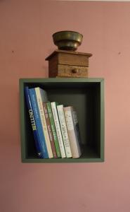 a book shelf with books and a vase on it at Ponte House in Piaia