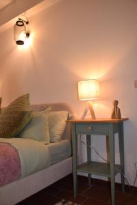 a bedroom with a bed and a table with a lamp at Ponte House in Piaia