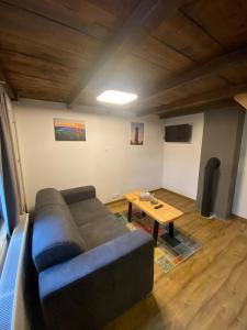 a living room with a couch and a table at Chaloupka Jeřmanice in Jeřmanice +8 photos
