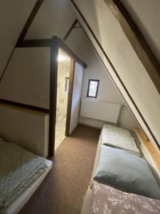 a attic room with two beds and a cross at Chaloupka Jeřmanice in Jeřmanice