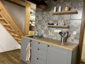 a kitchen with a sink and a counter top at Chaloupka Jeřmanice in Jeřmanice
