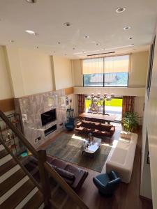 an aerial view of a living room with a fireplace at Villa Meg with Private Pool, Sauna Jacuzzi in Kadıköy