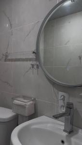a bathroom with a mirror and a toilet and a sink at Sant House Dilijan in Dilijan