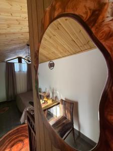 a room with a table and a chair and a mirror at Sant House Dilijan in Dilijan