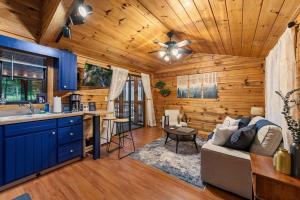 a kitchen and living room in a log cabin at The Racoons Nest in Copperhead Lodge in Blairsville