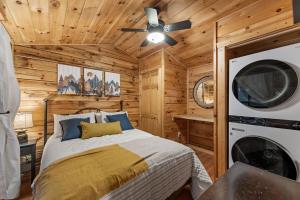 a bedroom with a bed and a washer and dryer at The Racoons Nest in Copperhead Lodge in Blairsville
