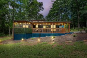 a small house with lights in a yard at The Racoons Nest in Copperhead Lodge in Blairsville +37 photos