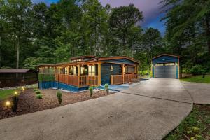 a house with a garage in the middle of a driveway at The Racoons Nest in Copperhead Lodge in Blairsville