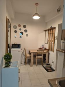 a kitchen with a table and a dining room at Studio Nice in Old Town Tonitza in Bucharest