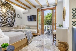 a bedroom with a bed and a couch at Villa Apostolis Studios in Skopelos Town