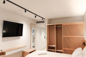 a living room with a flat screen tv on a wall at Thinalos Hotel in (( Saoúli ))
