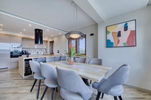a kitchen and dining room with a wooden table and chairs at Masanda in Ždrelac